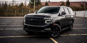 Full view of a custom blackout 2021 Chevy Tahoe with chrome delete trim.