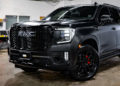 Satin black GMC Yukon Denali with chrome delete trim and blackout styling.