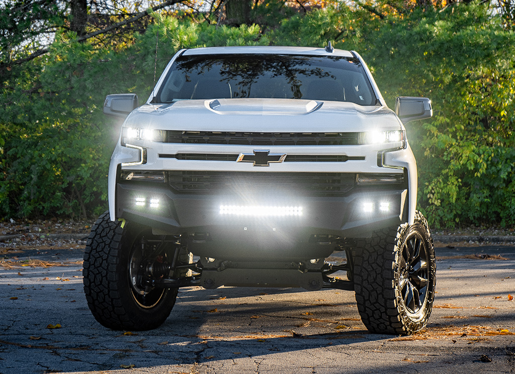 LED lights on the front end of a custom 2022 Chevy Silverado offroad truck.