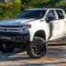 White 2022 Chevy Silverado customized with offroad mods and accessories.