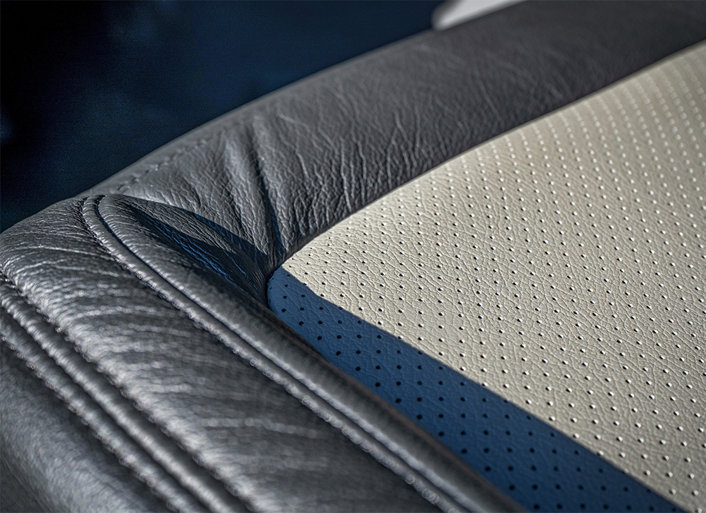 Close-up of black and gray perforated custom leather seating.