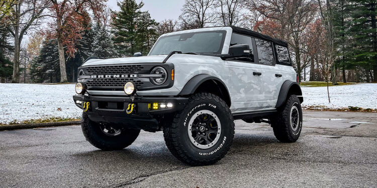 2022 Ford Bronco with an arctic camo vinyl wrap and offroad upgrades.
