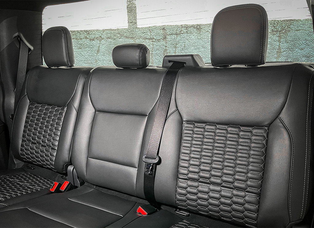 Custom black leather and white stitching upholstery on the seats of a Ford F-150. 