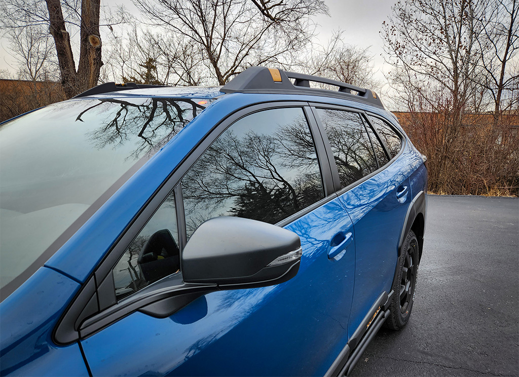 Window tint on a blue Subaru Outback