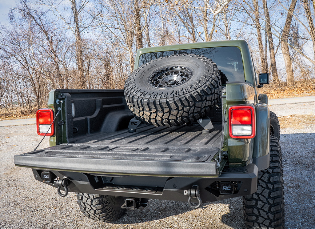 Bed mounted spare tire rack installed on an offroad Jeep Gladiator build