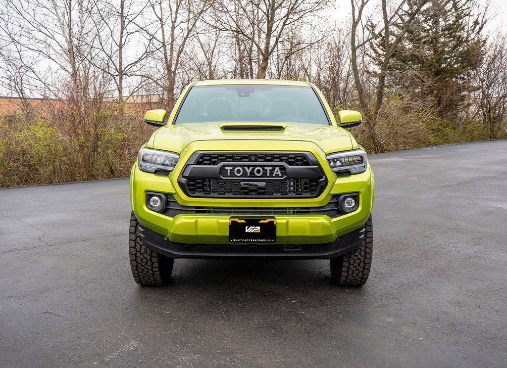 Electric Lime 2023 Toyota Tacoma with a blackout replacement grille