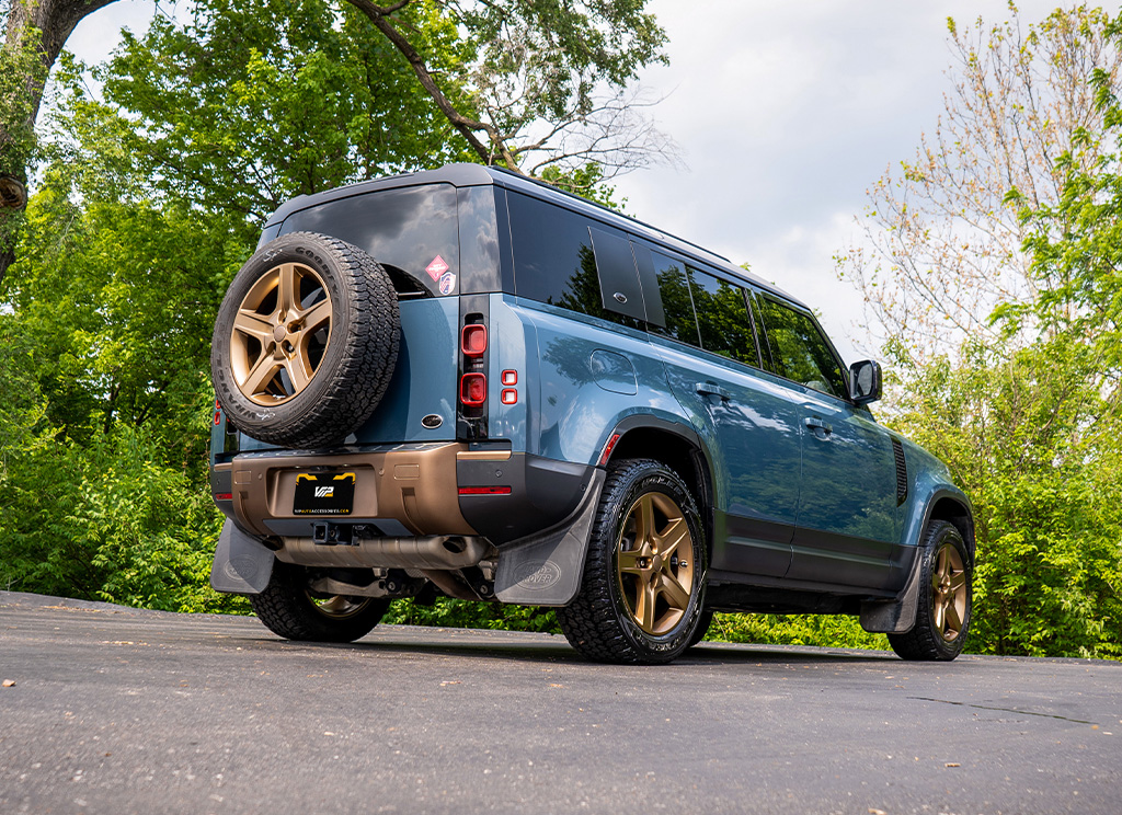Rear angle view of custom Land Rover Defender 110 that has bronze accents.