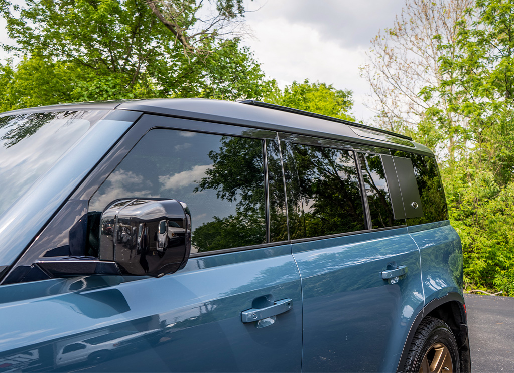 Satin black roof wrap and tinted windows on a 2020 Land Rover defender 110 SUV.