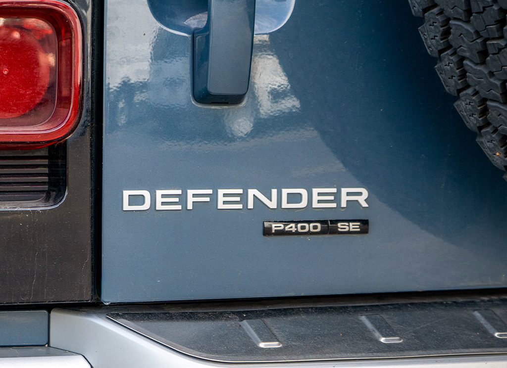 Factory Land Rover Defender tailgate nameplate.