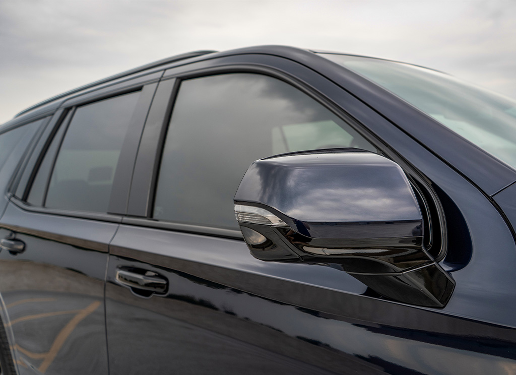 mirror cap and window tint on a GMC Yukon SUV.