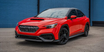 Custom red 2023 WRX with a chrome delete and two-tone wrap.