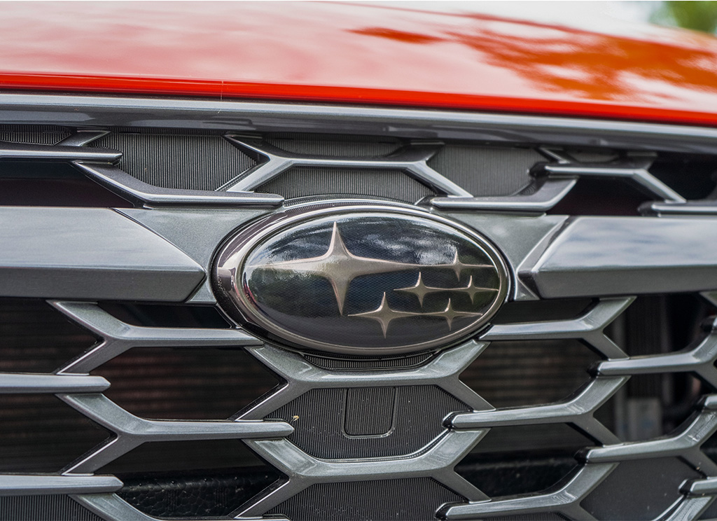 Tinted Subaru emblem close-up.