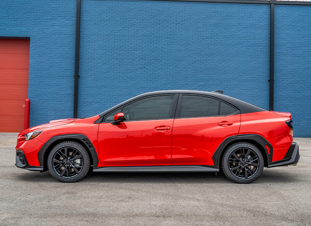 Side profile of a custom red Subaru WRX