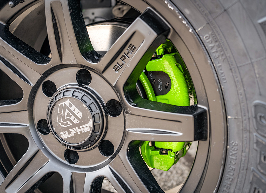 Lime green painted calipers behind Alphaequipt Command wheels.