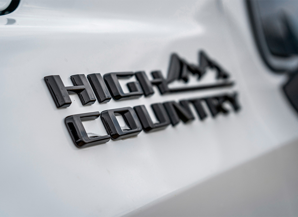 Close up of a blackout Chevy High Country nameplate.