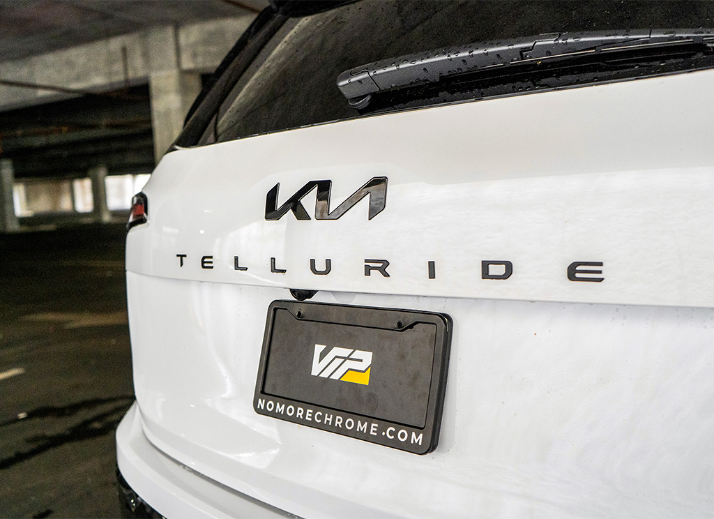 Replacement blackout emblem and nameplate lettering on a 2023 Kia Telluride SUV.