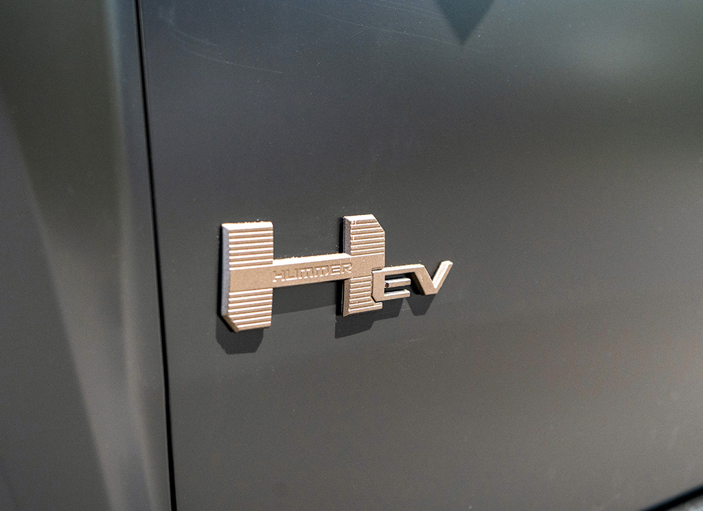 Custom Hummer EV badge painted bronze aftermarket.
