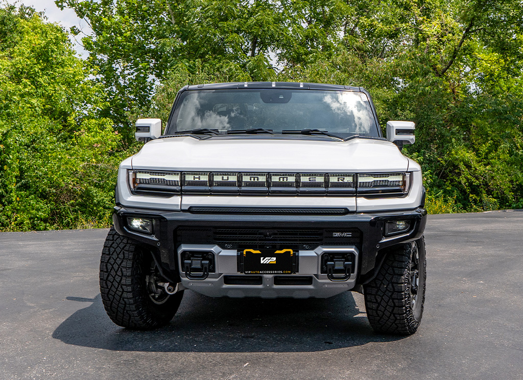 White GMC Hummer EV front view with stainless steel skid plate.