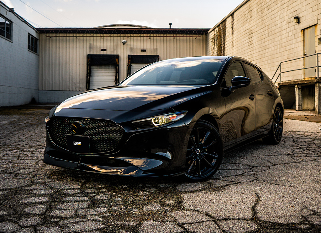 Blackout mazda3 hatchback with tinted windows.