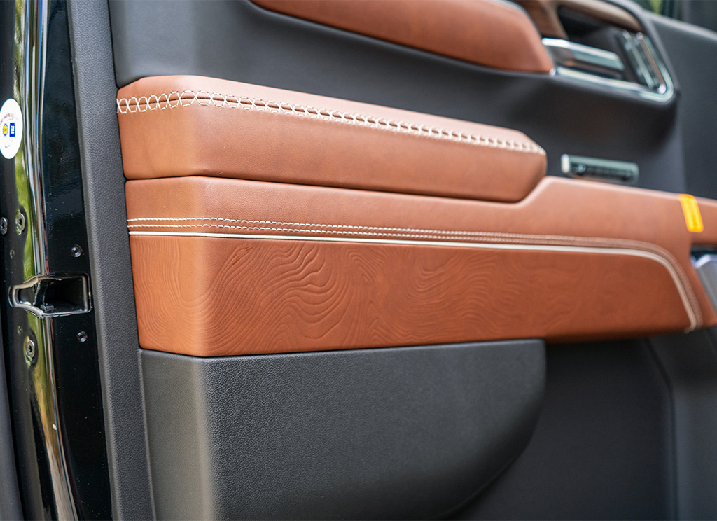 Topographic leather door armrest on the 2024 GMC Sierra Denali Ultimate edition.