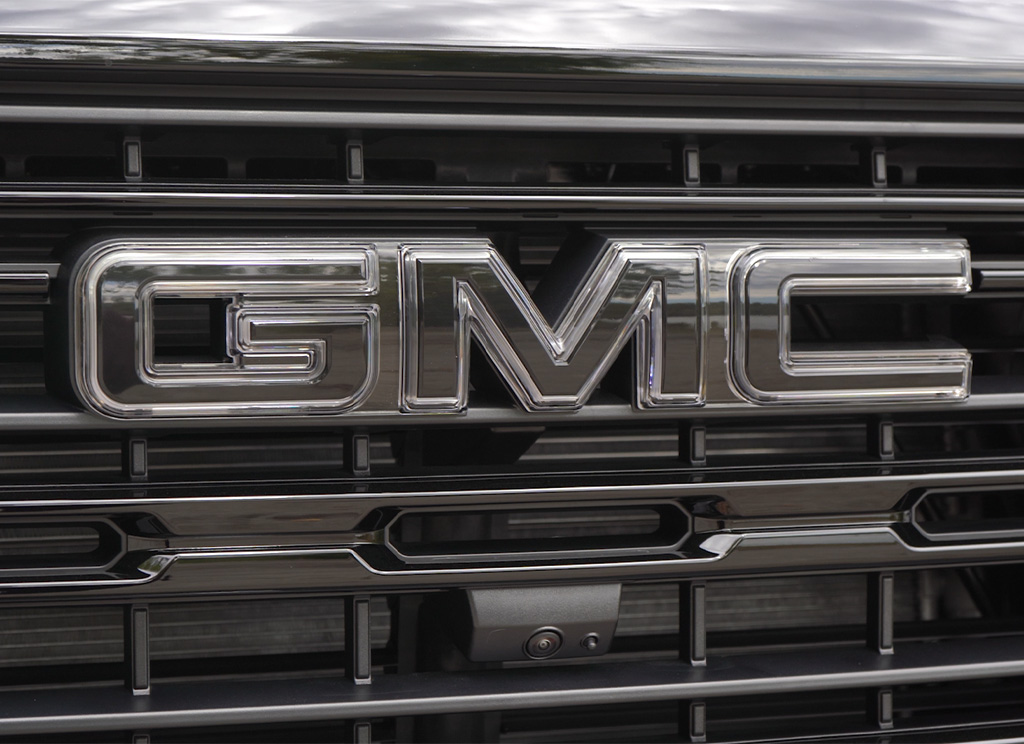 Close-up of an LED illuminated GMC emblem.