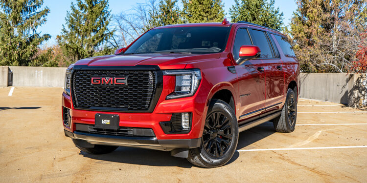 Volcanic Red 2023 GMC Yukon Denali with chrome delete trim.