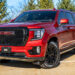 Volcanic Red 2023 GMC Yukon Denali with chrome delete trim.