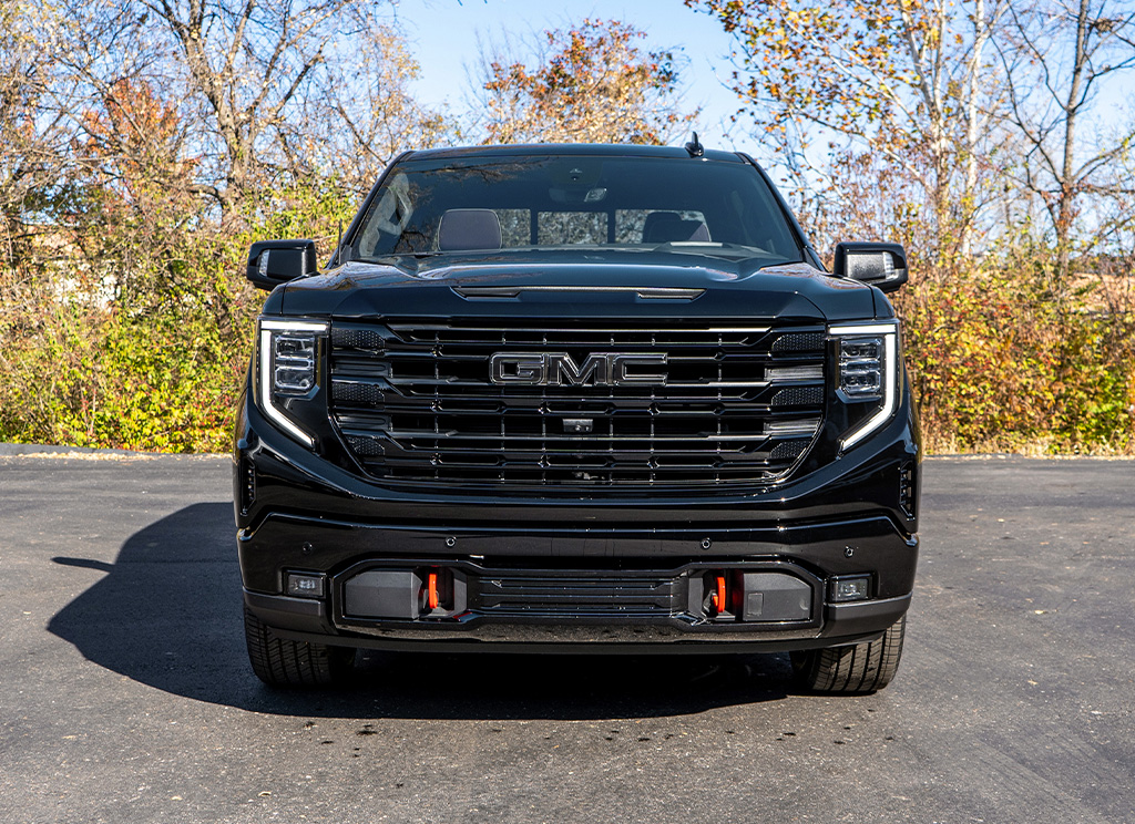 2024 GMC Sierra Denali truck with a blackout grille and black bumper accent.
