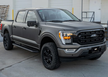 Custom 2024 Ford F-150 truck with blackout trim and a satin gray vinyl wrap.