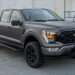 Custom 2024 Ford F-150 truck with blackout trim and a satin gray vinyl wrap.