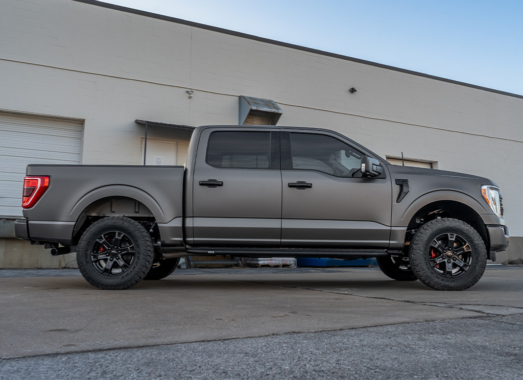 Side profile of a 2024 Ford F-150 full-size truck with a satin gray vinyl wrap.