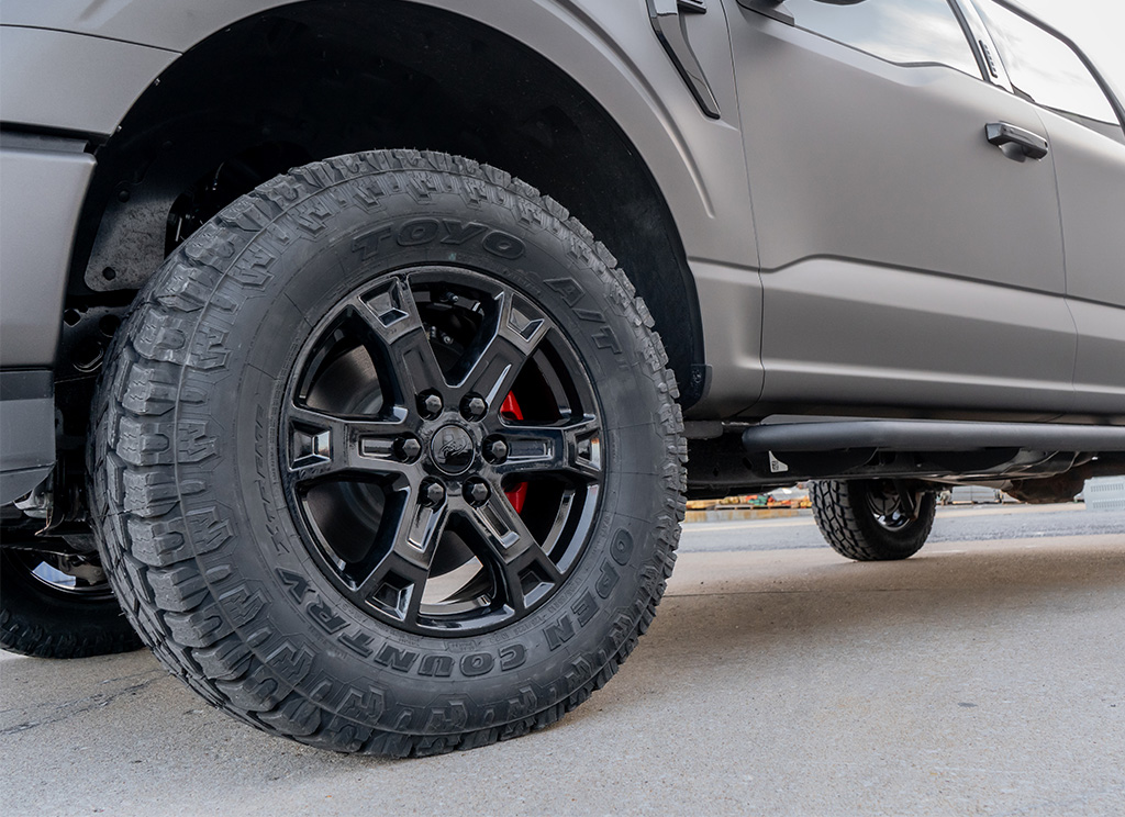 Toyo AT 2 tires and black powder coated wheels on a custom Ford F-150 truck.