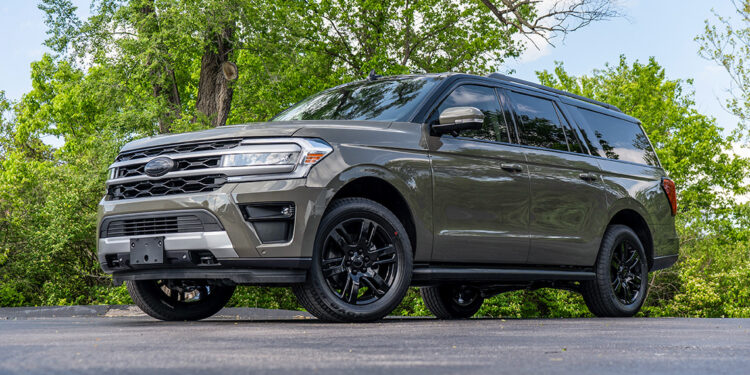 Custom 2024 Wild Green Ford Expedition with blackout emblems and a black two-tone roof vinyl wrap.
