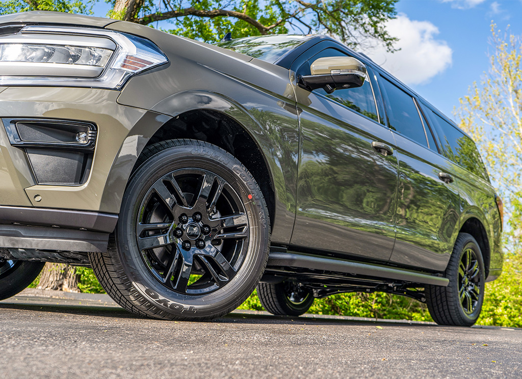 Low angle view of Ford Expedition wheels which are powder coated with a black finish.
