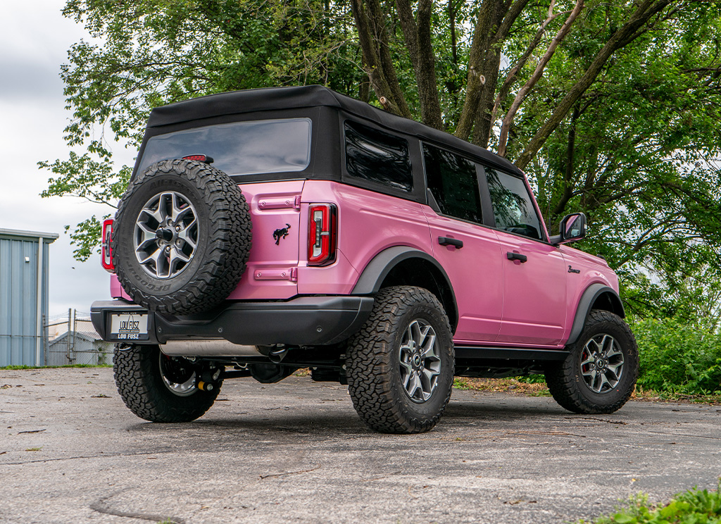 Rear view of a pink Ford Bronco custom build.