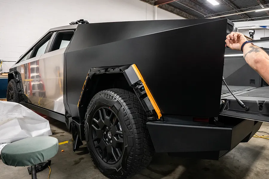 flat panels on a cybertruck being wrapped