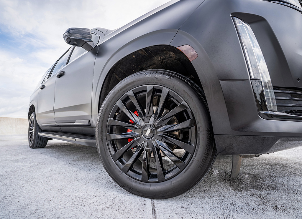 gloss black powder coated wheels on a cadillac escalade