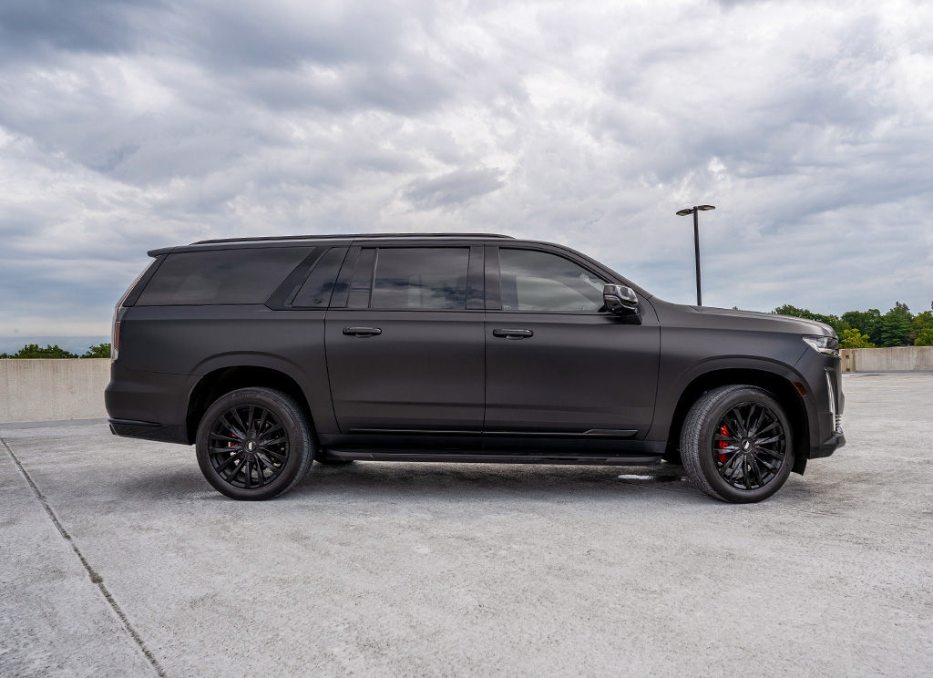 side view of satin black cadillac