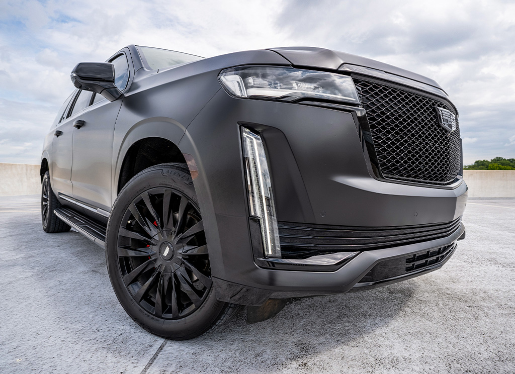 front end of satin black cadillac escalade