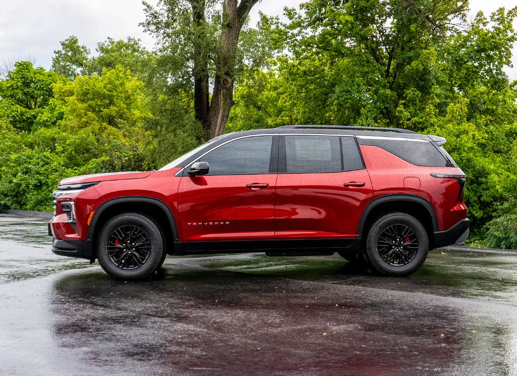 Side profile of a custom red and black 2024 Chevy Traverse.