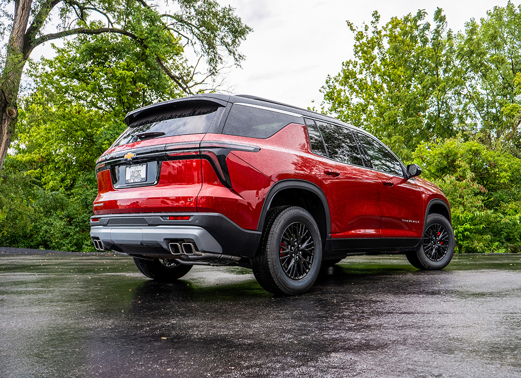 Rear angle view of a custom two-tone red and black Traverse.