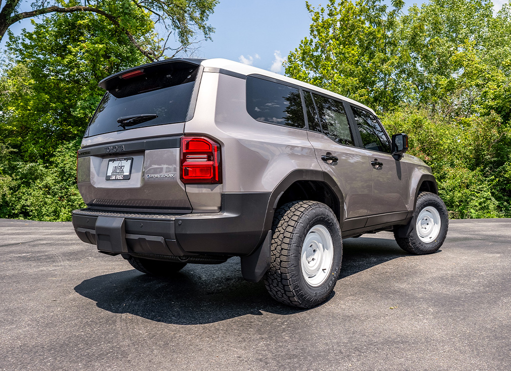 Rear angle view of a custom 2024 Toyota Land Cruiser with accessories and window tint.