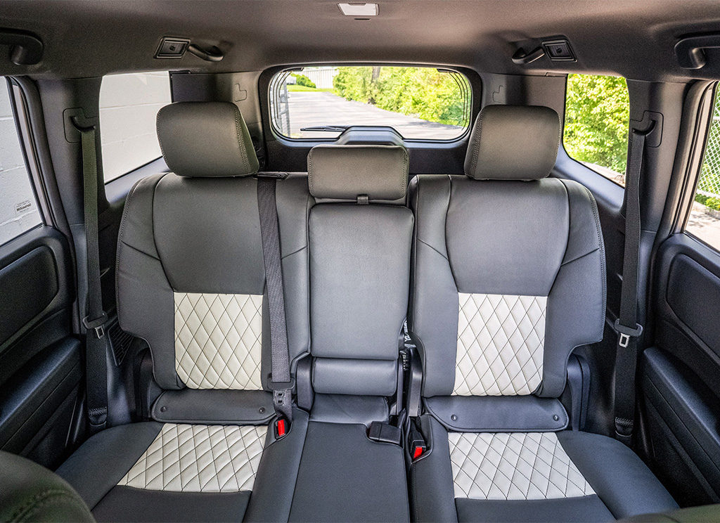 Gray and white custom leather upholstery with diamond stitching.