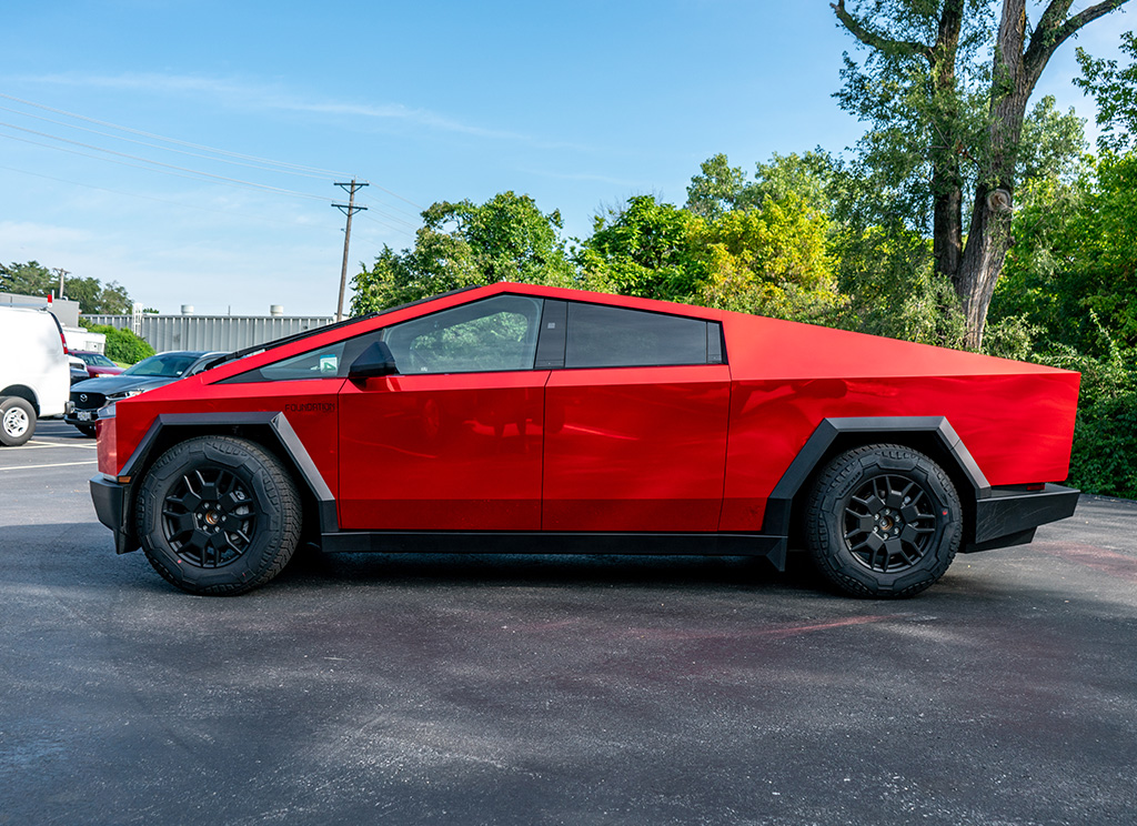 Side profile of a red chrome Cybertruck wrap.