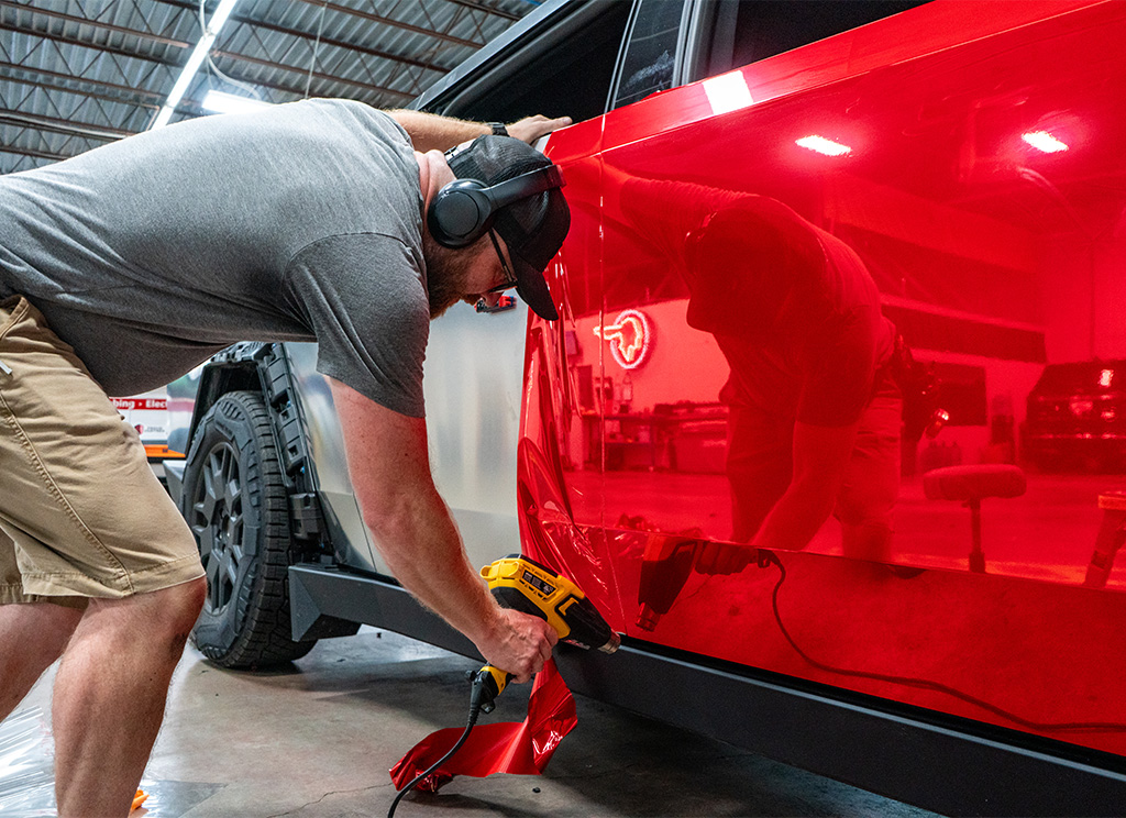 Installing the red super chrome film on the Cybertruck.