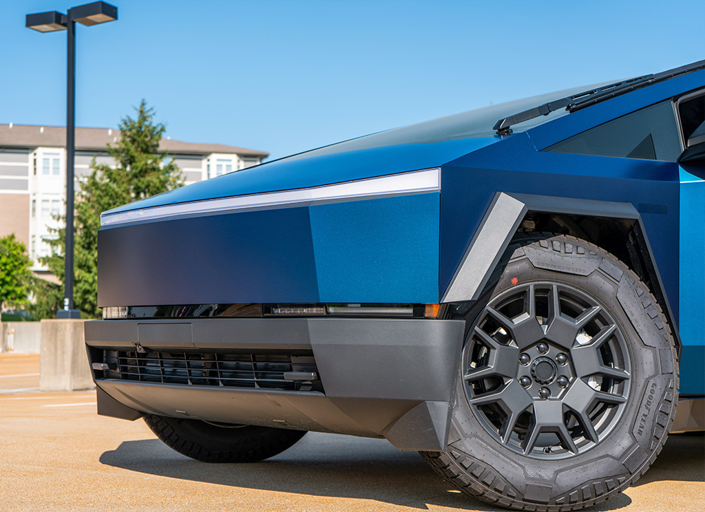 Cybertruck front end with a blue vinyl wrap.