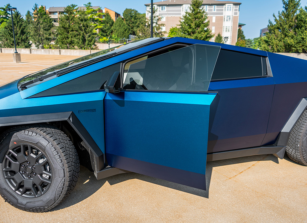 Tesla Cybertruck with a blue color flip wrap and window tint.