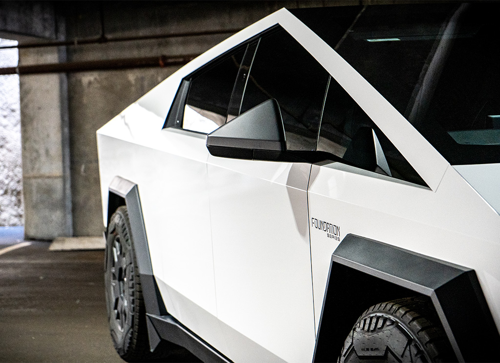 Tinted windows on a customized Cybertruck with a white vinyl wrap.