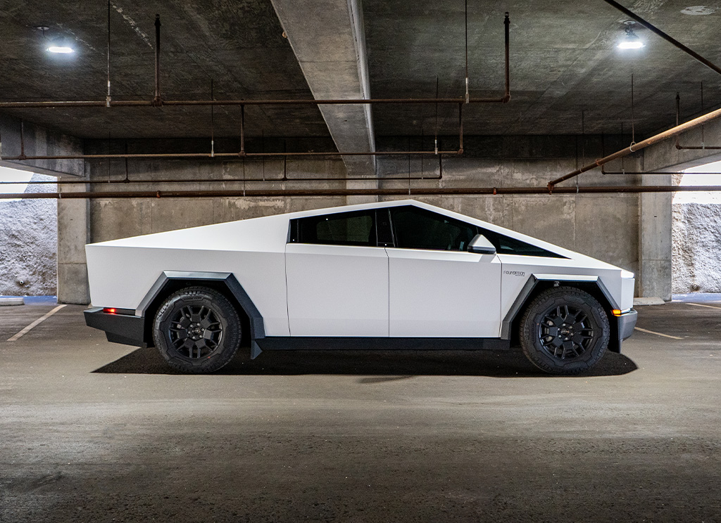 Side profile view of a white Tesla Cybertruck wrap.