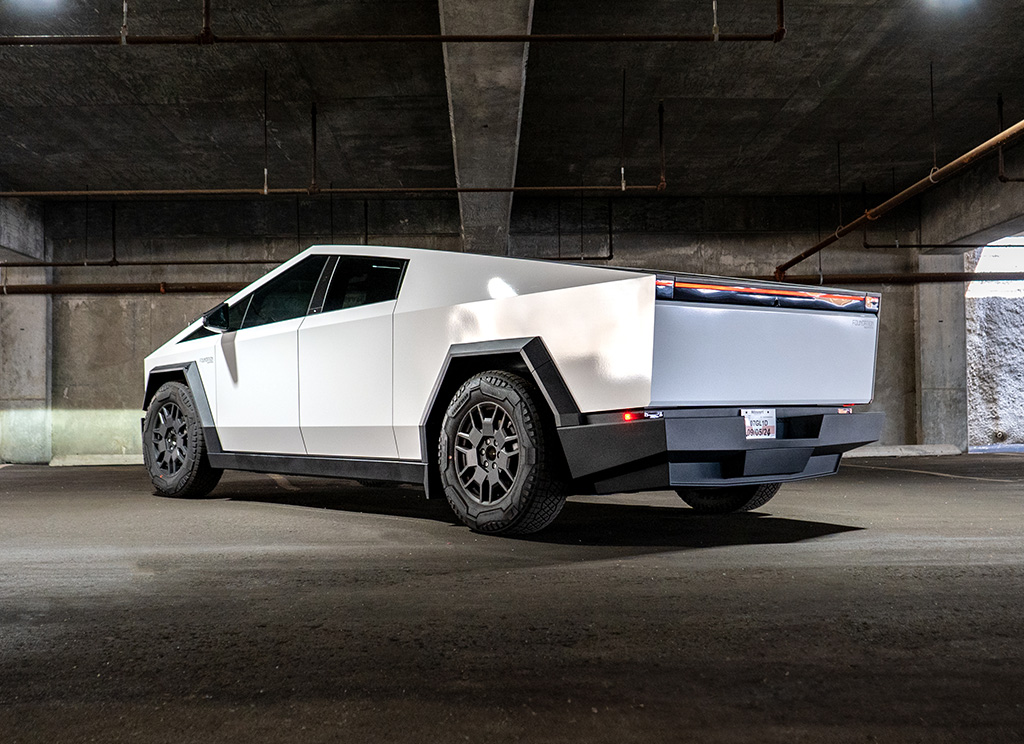 Rear view of a Tesla Cybertruck wrapped in white vinyl.